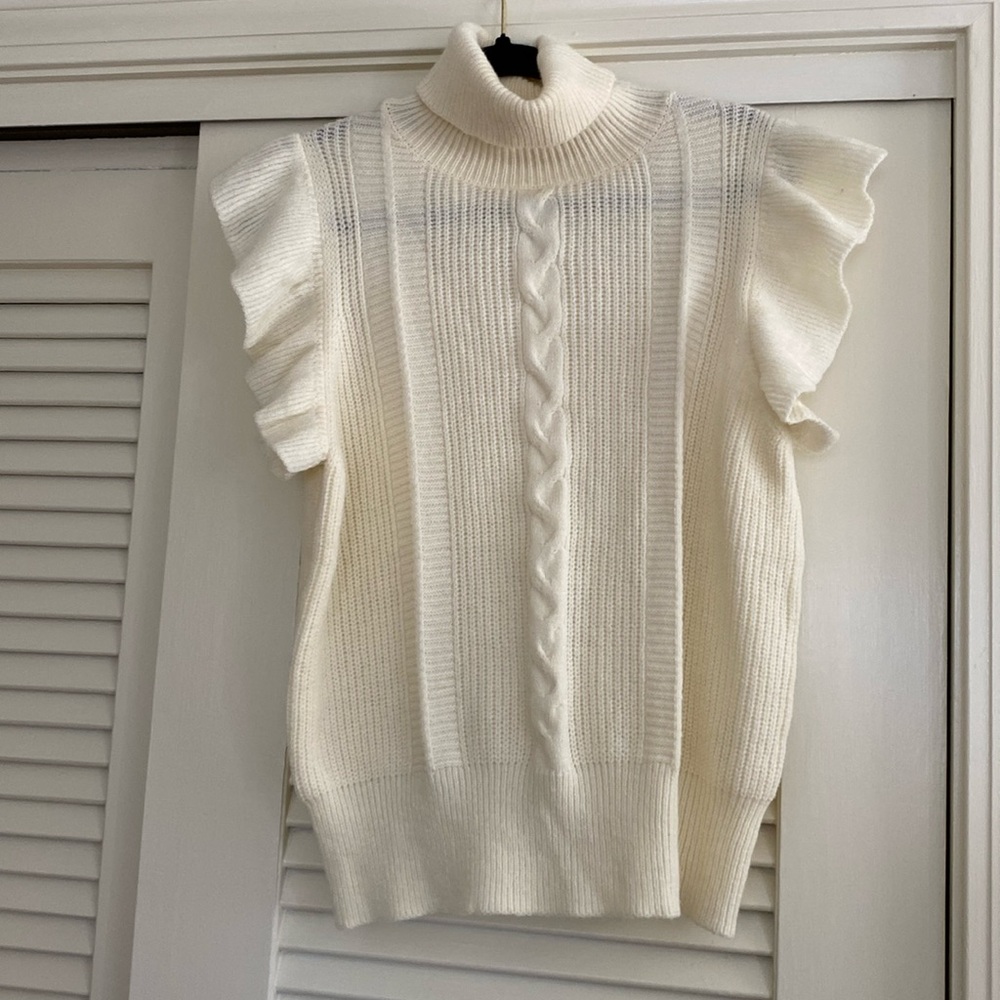 Cream sleeveless turtleneck sweater